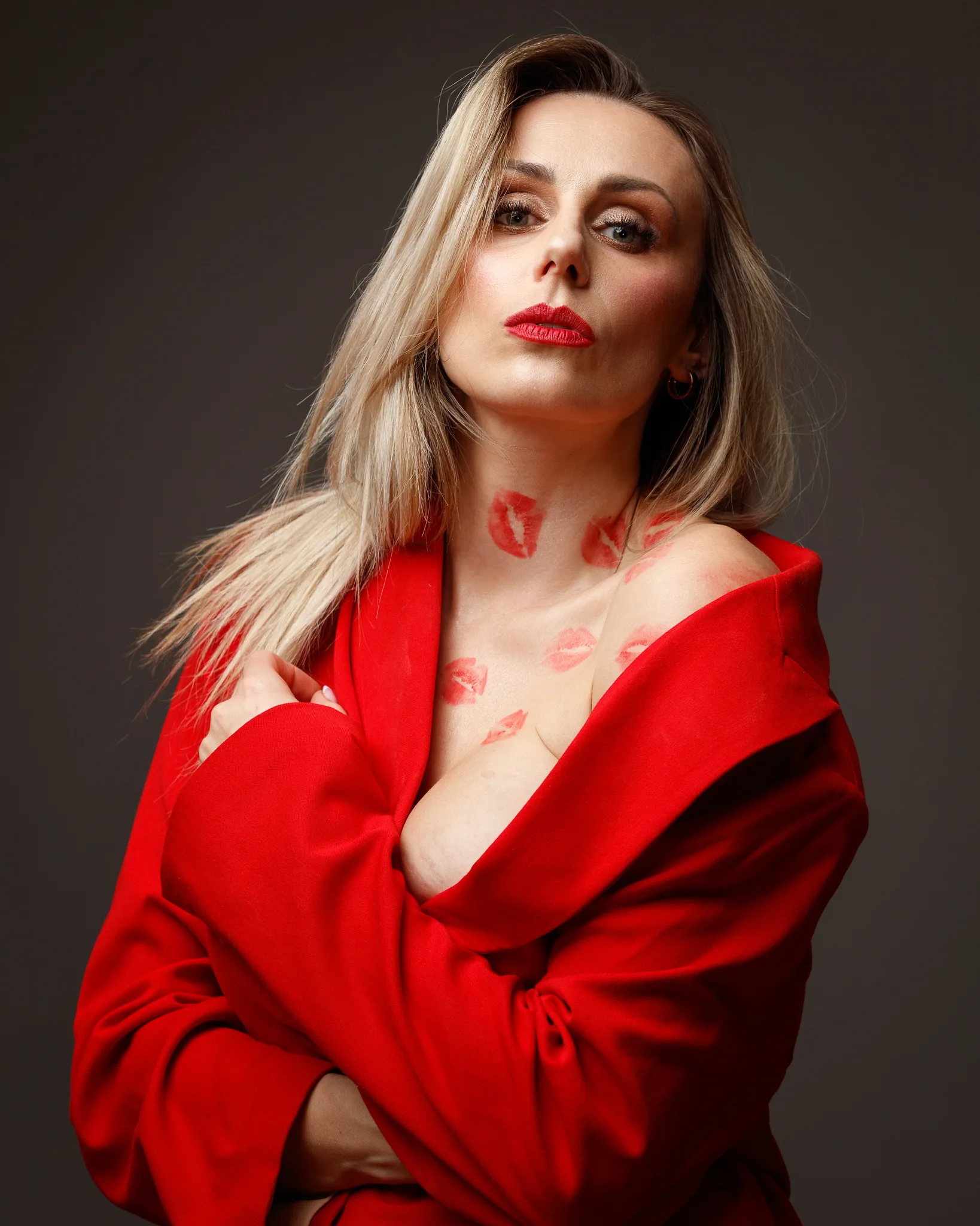 Woman in red coat with lipstick marks.