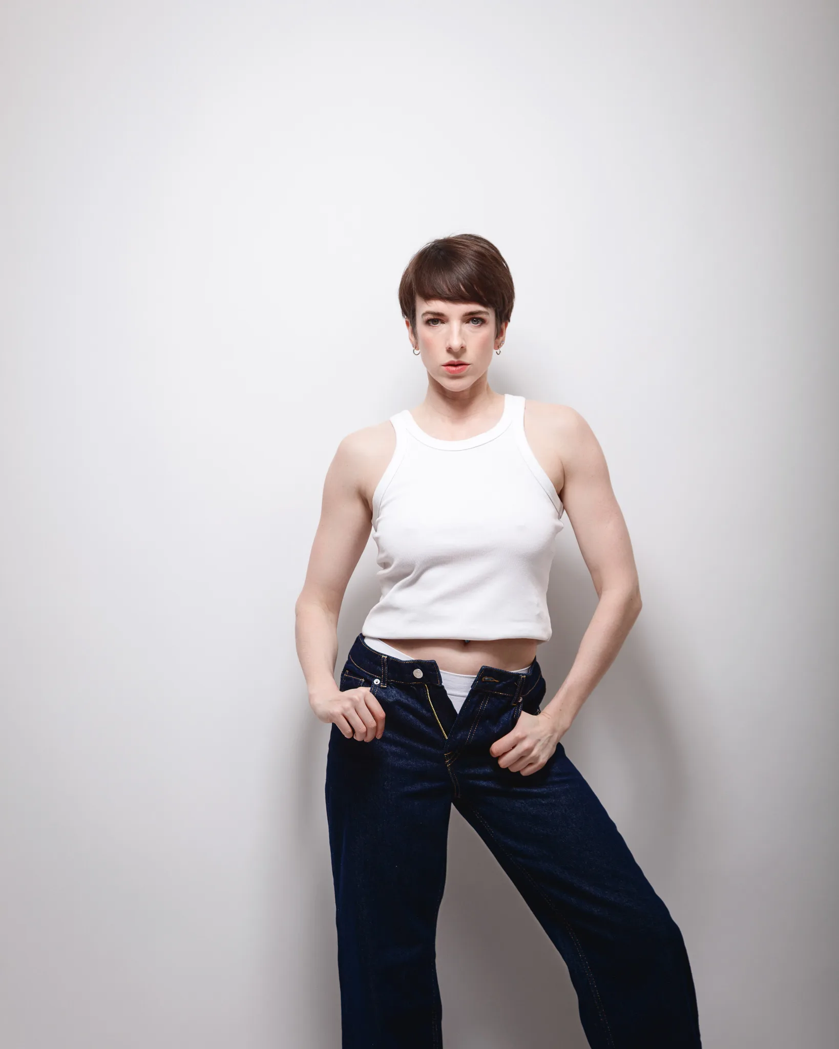 Person in white tank top and jeans