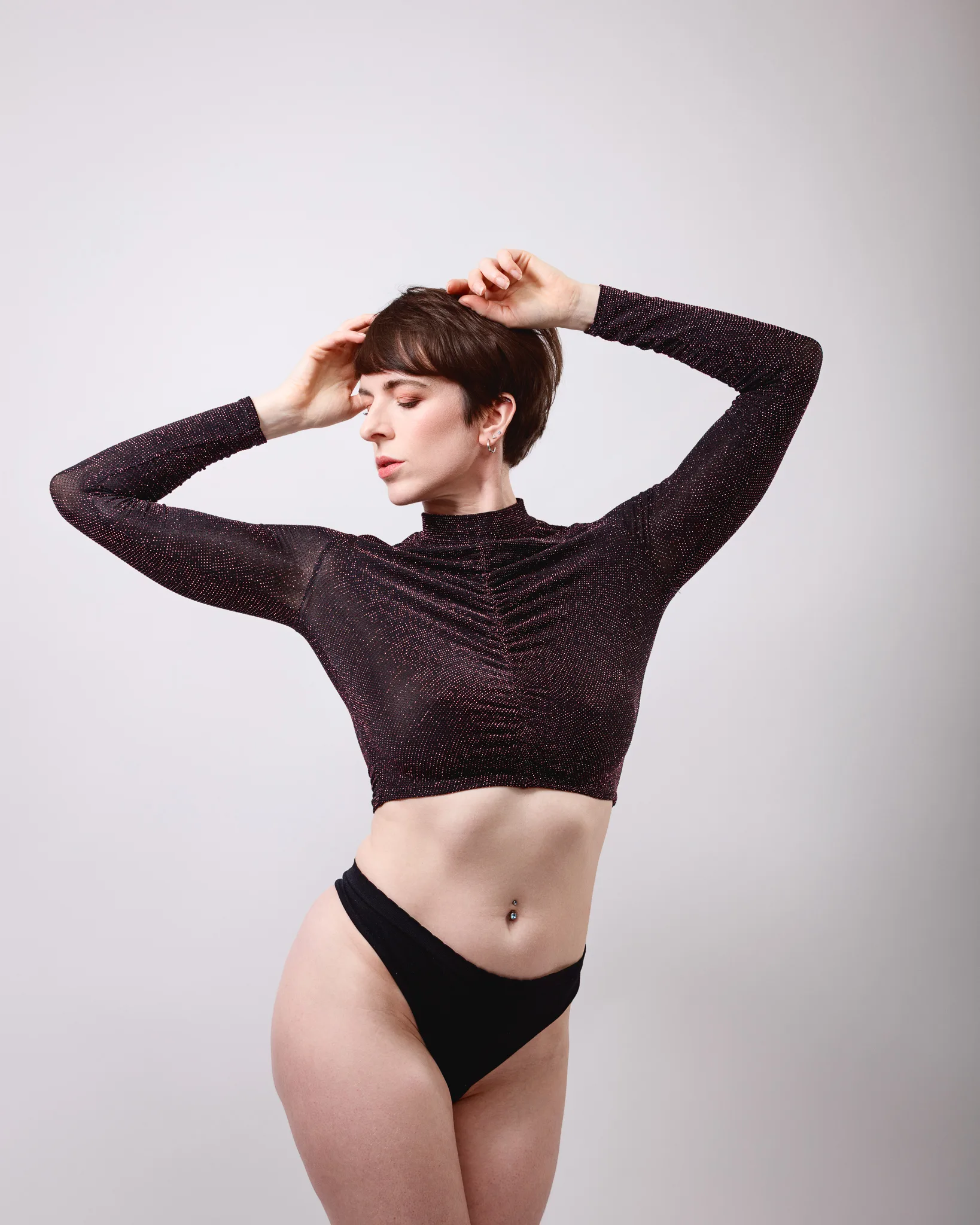 Woman posing in black top and underwear