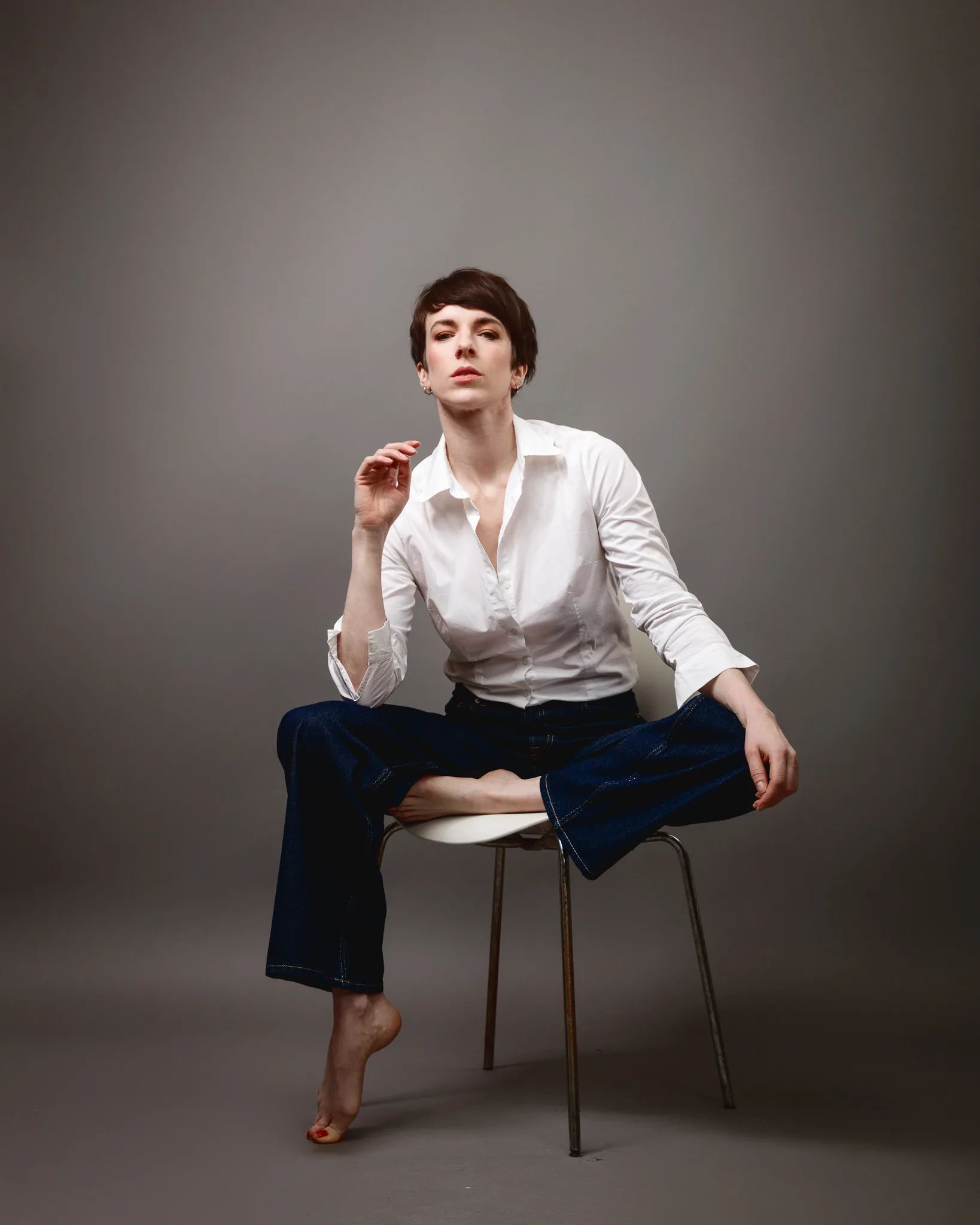Person in white shirt sitting cross-legged.