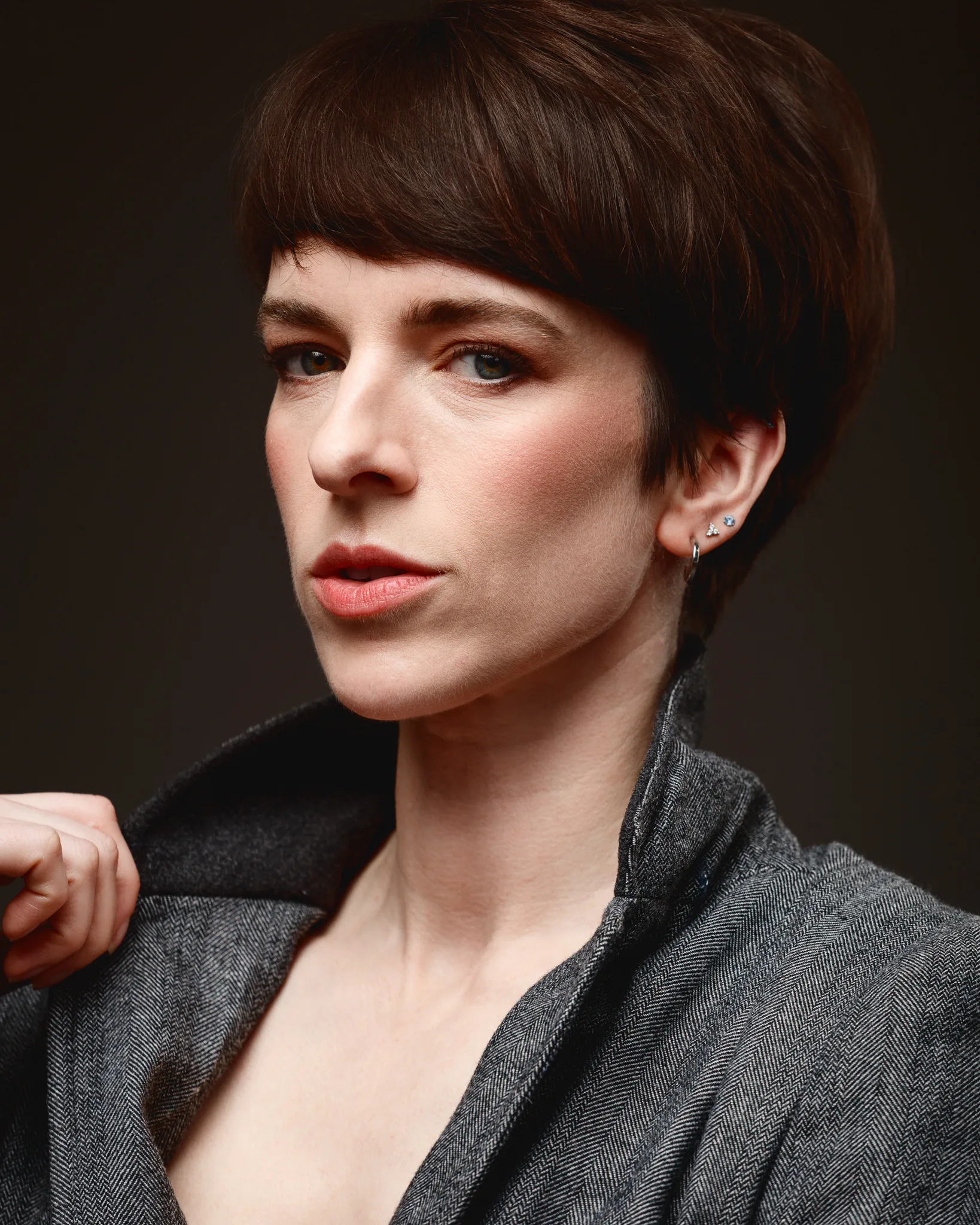 Portrait of person with short, brown hair and jacket.
