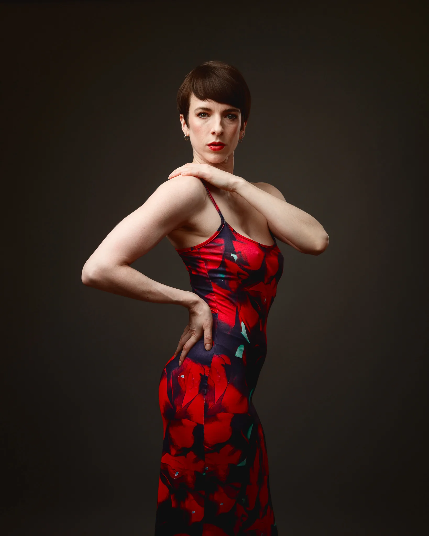 Person wearing a vibrant red floral dress