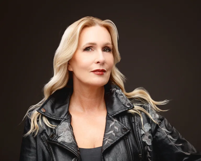 Blonde woman in embroidered black leather jacket