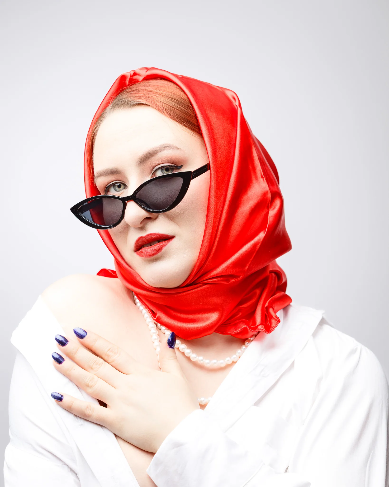 Woman in red headscarf and sunglasses