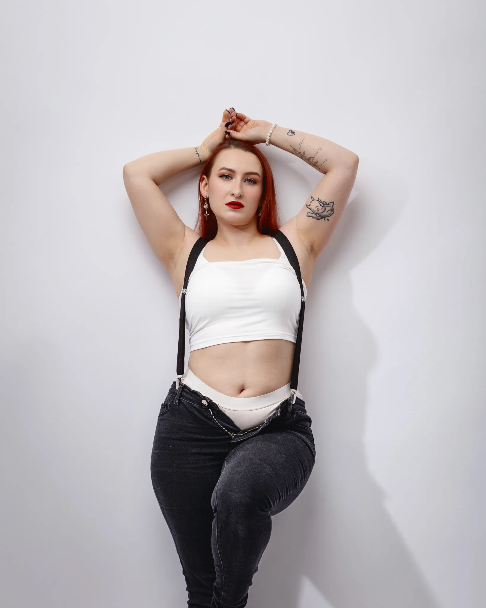 Woman posing confidently against white background.