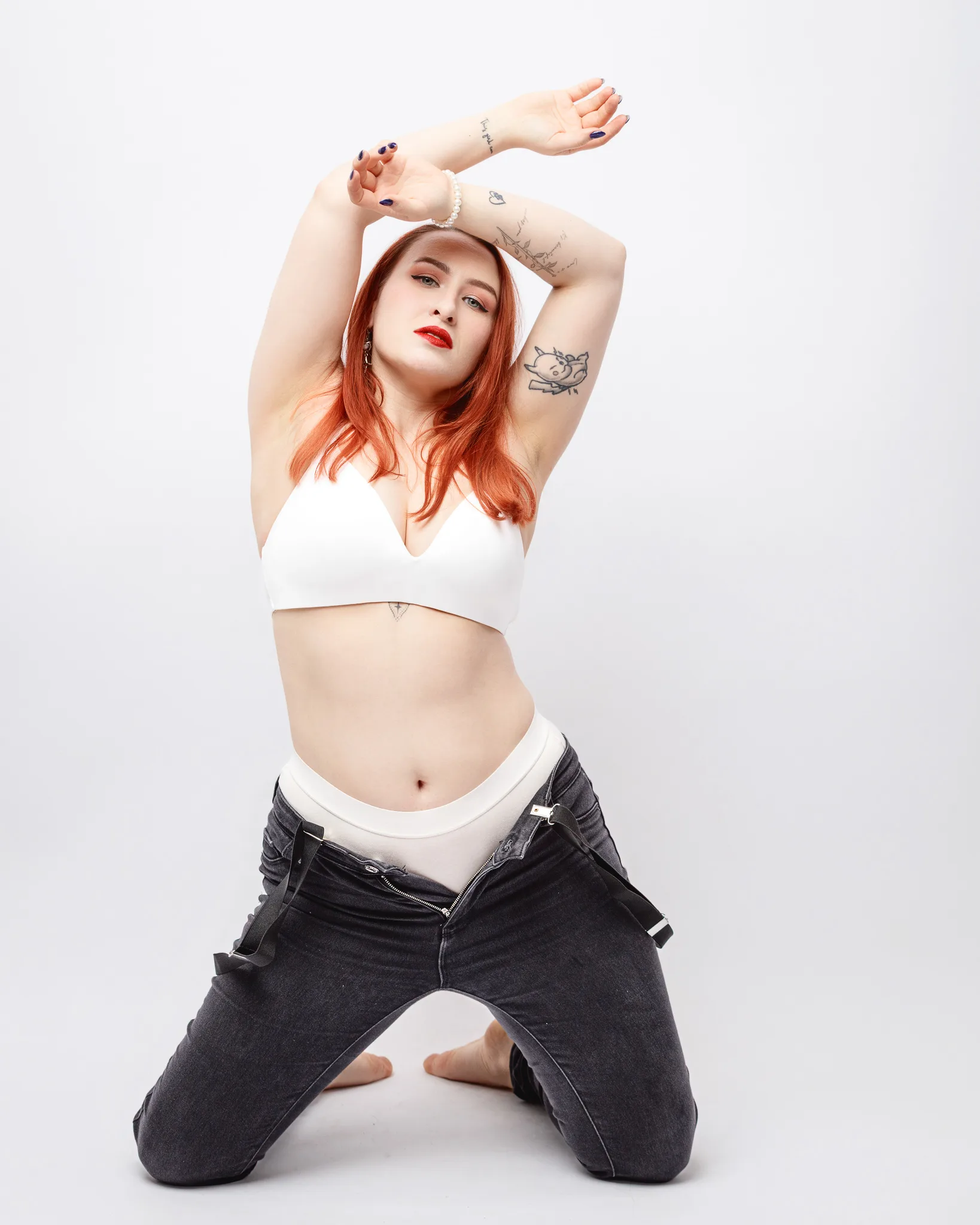 Person posing in stylish clothing on white background.