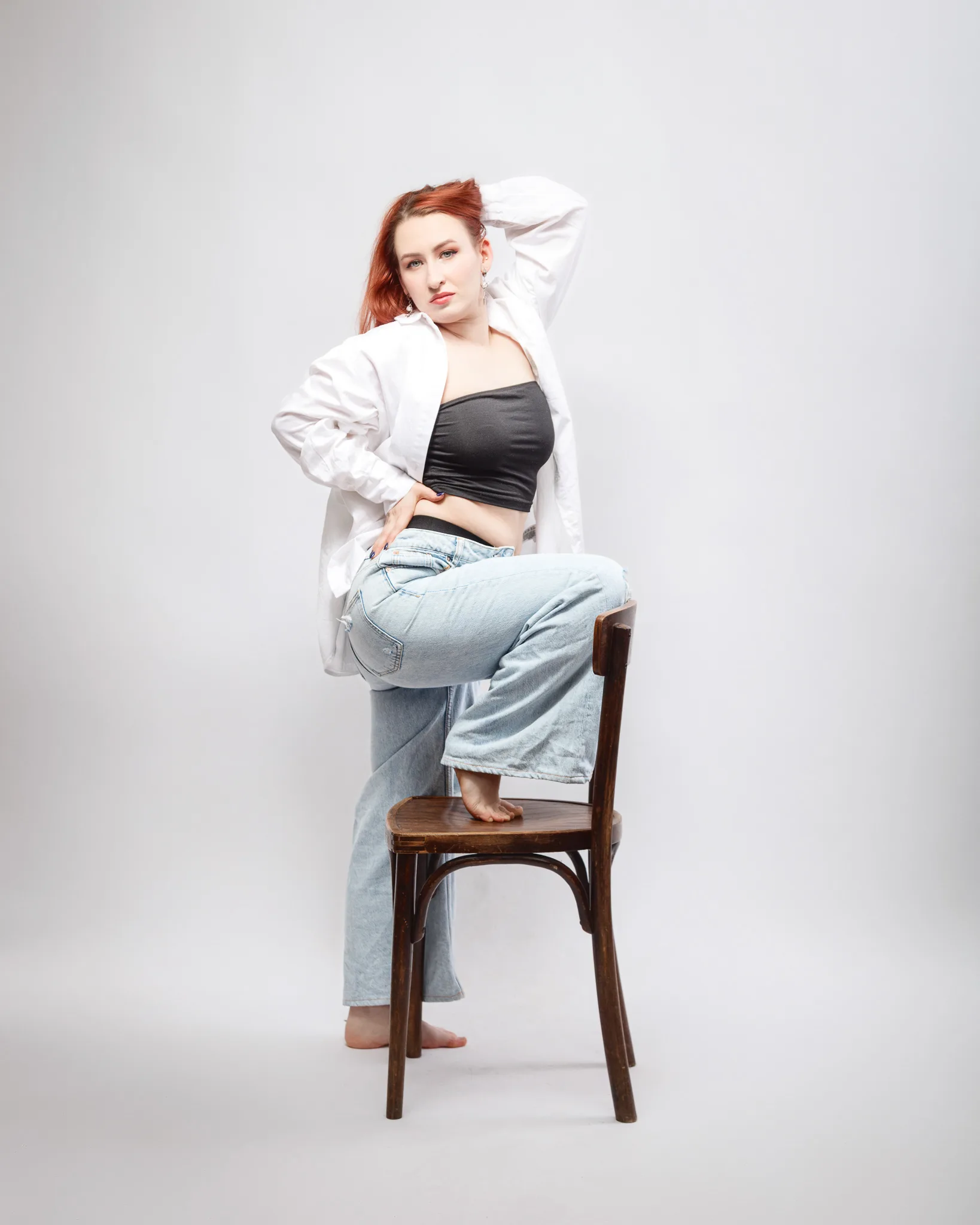 Woman posing on chair in casual outfit