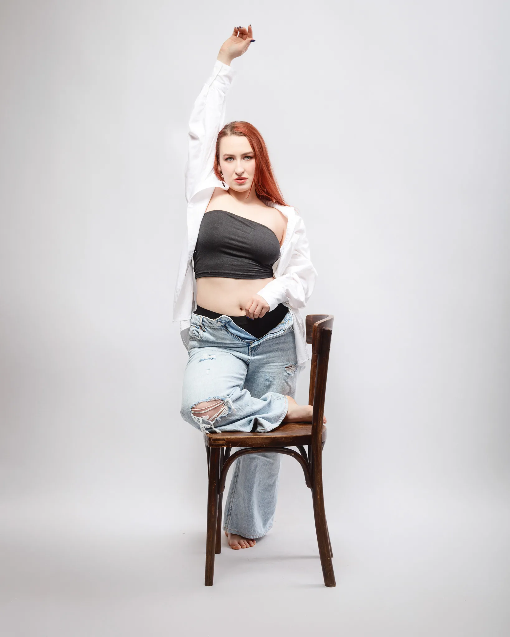 Woman posing stylishly on chair indoors