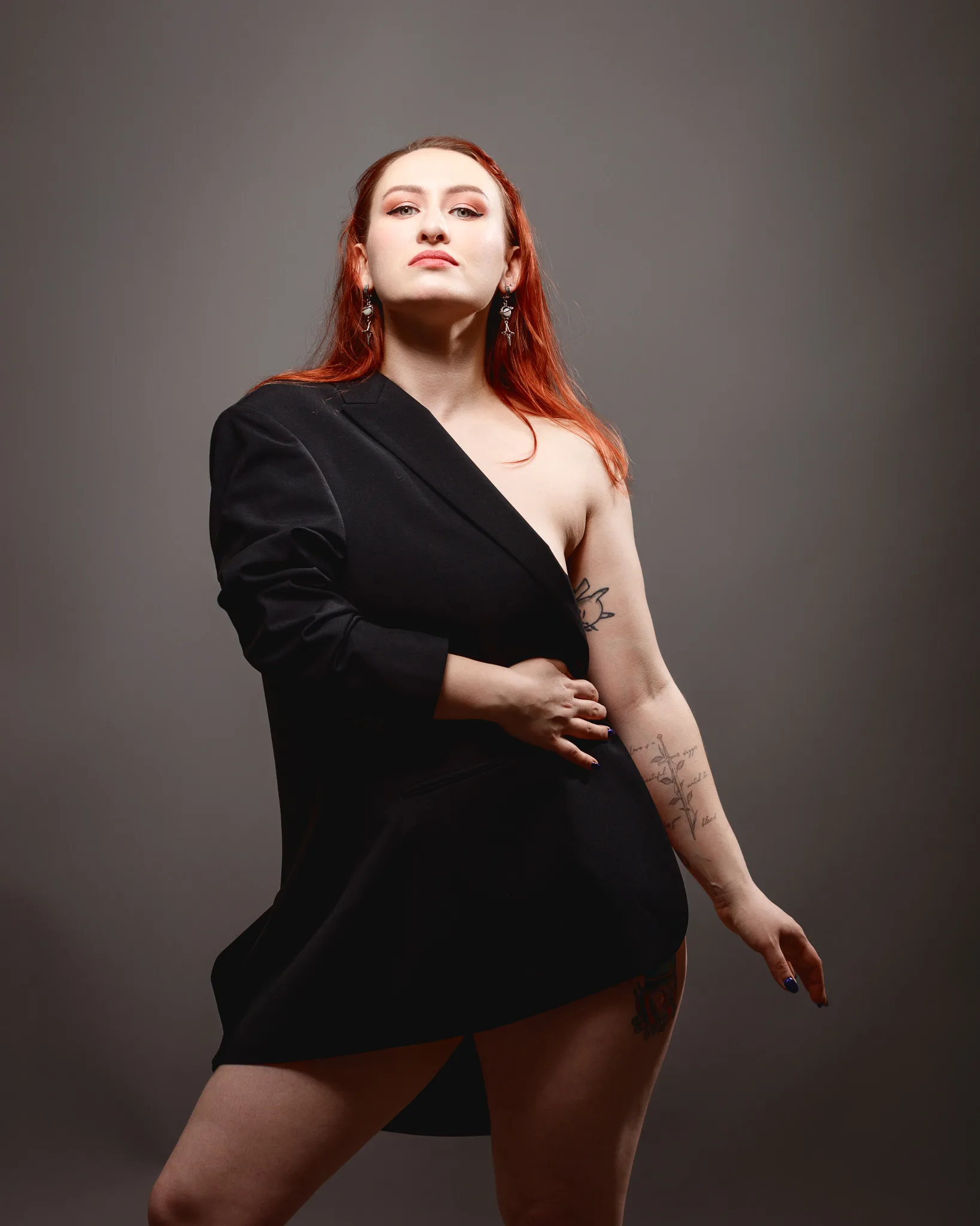 Woman in asymmetrical outfit posing confidently