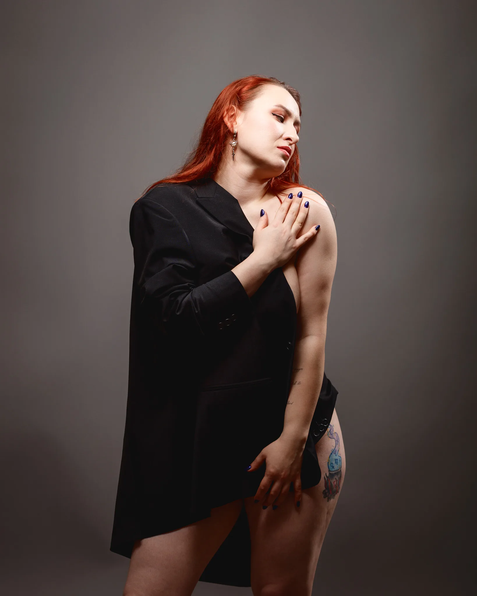 Person in black jacket posing with closed eyes.