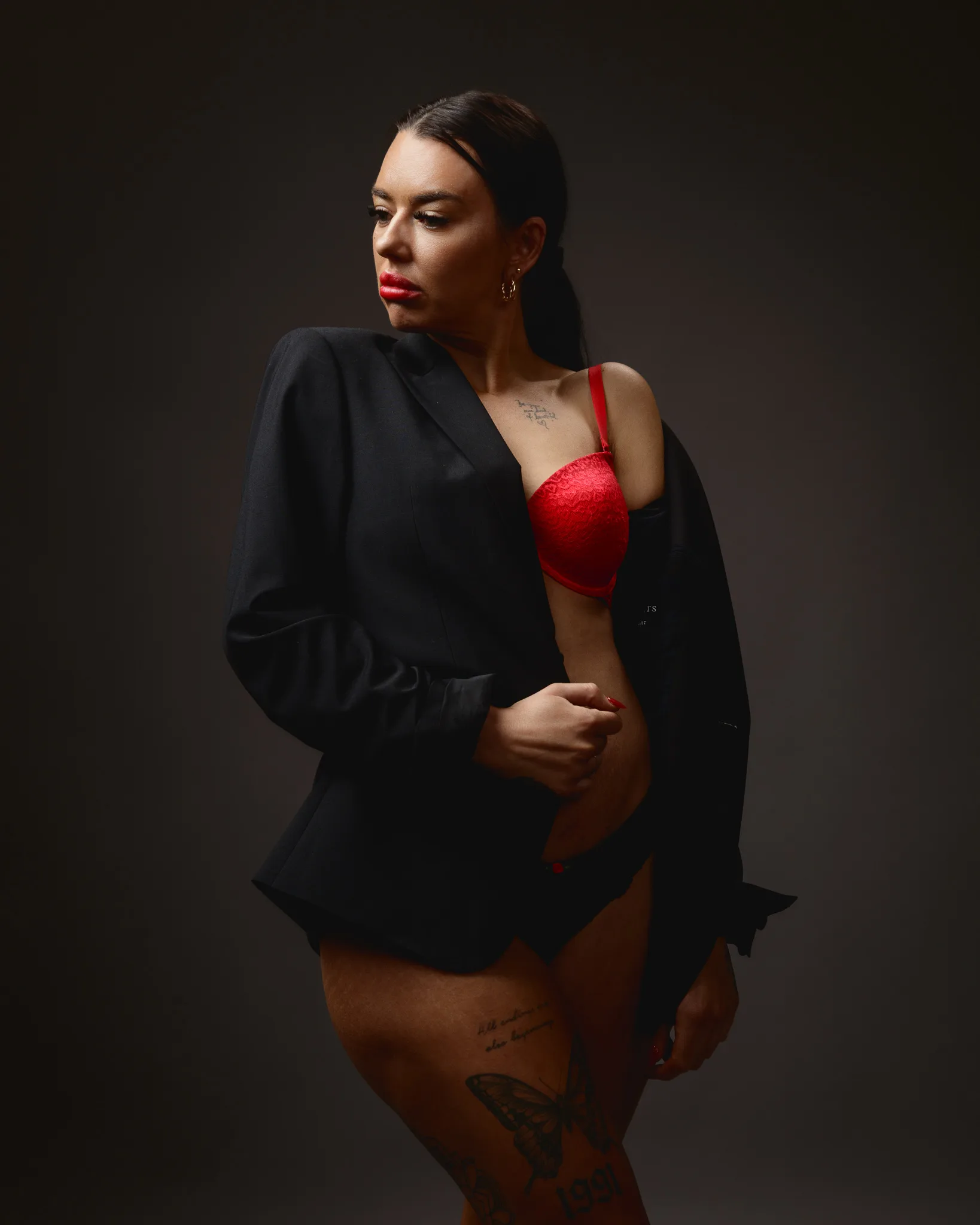 Woman in red lingerie and black jacket