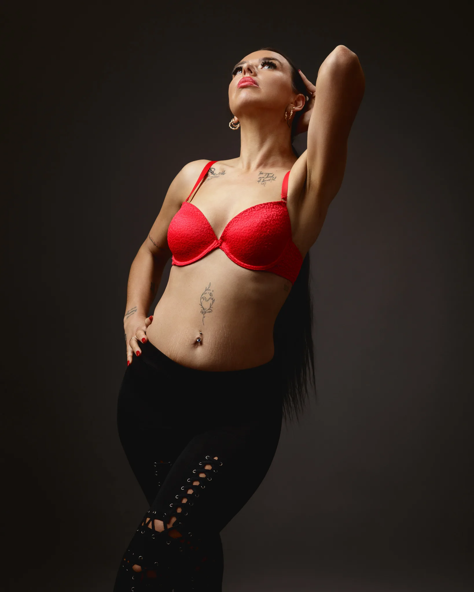 Woman posing in red bra and black leggings
