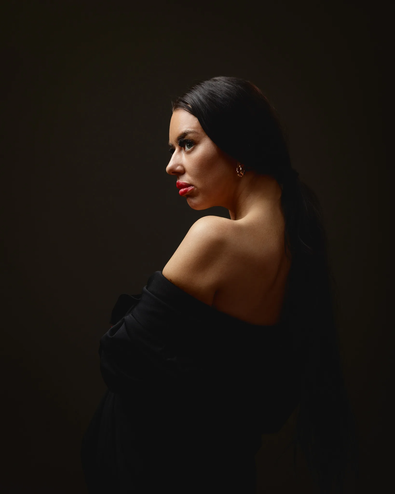 Woman in a dark, moody portrait pose