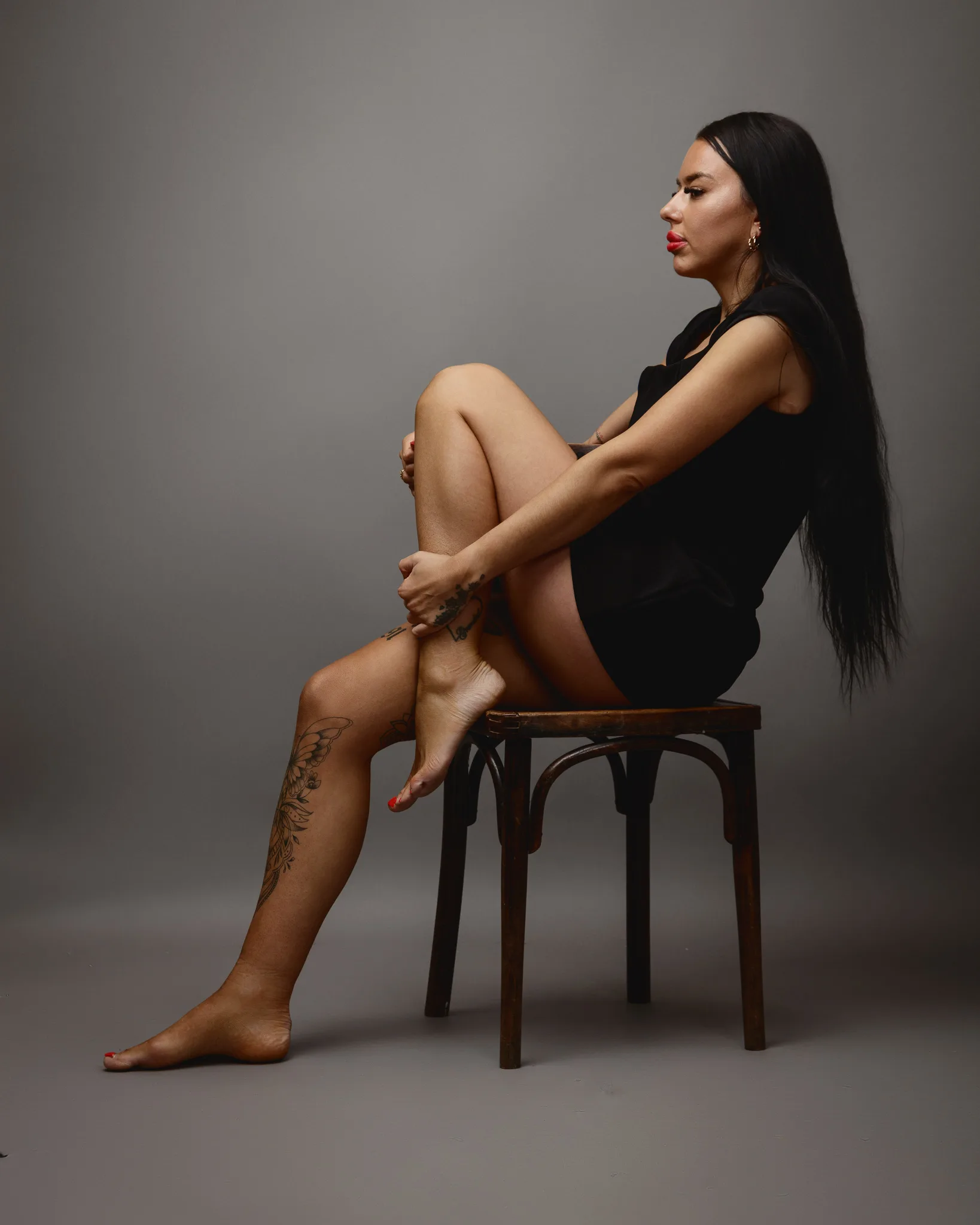 Woman seated on a wooden chair