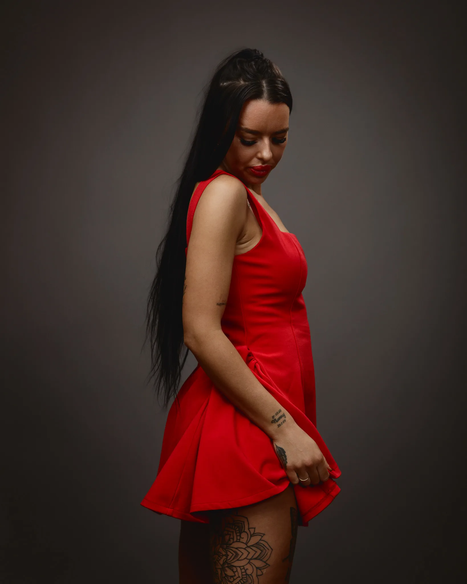 Woman in red dress with tattoos