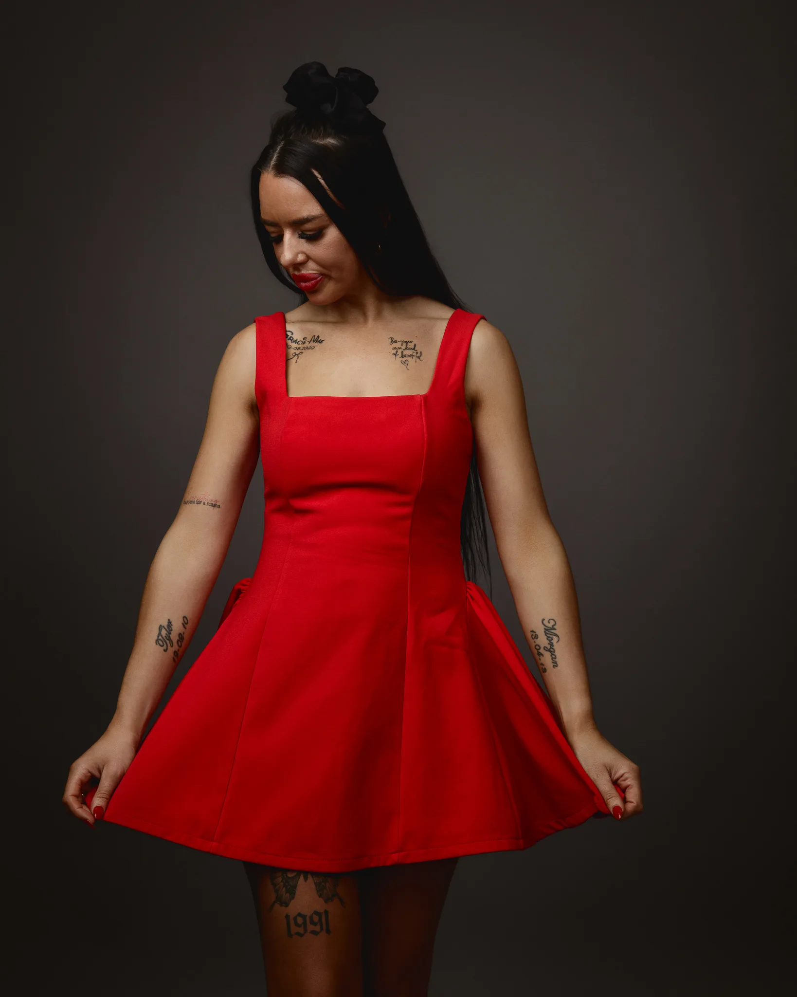 Woman in red dress looking down.