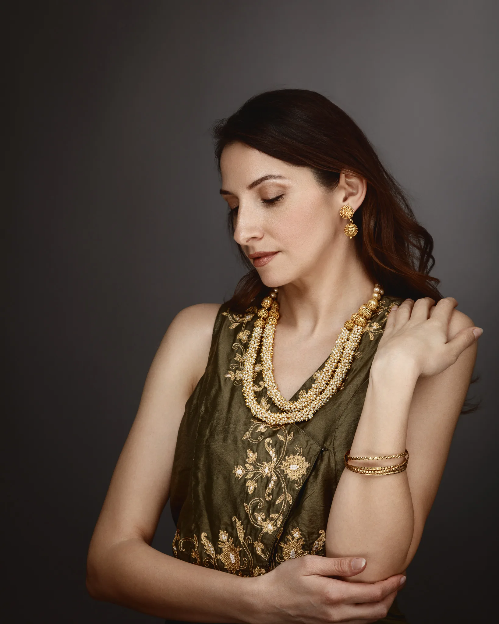 Woman in elegant ethnic attire with jewellery.