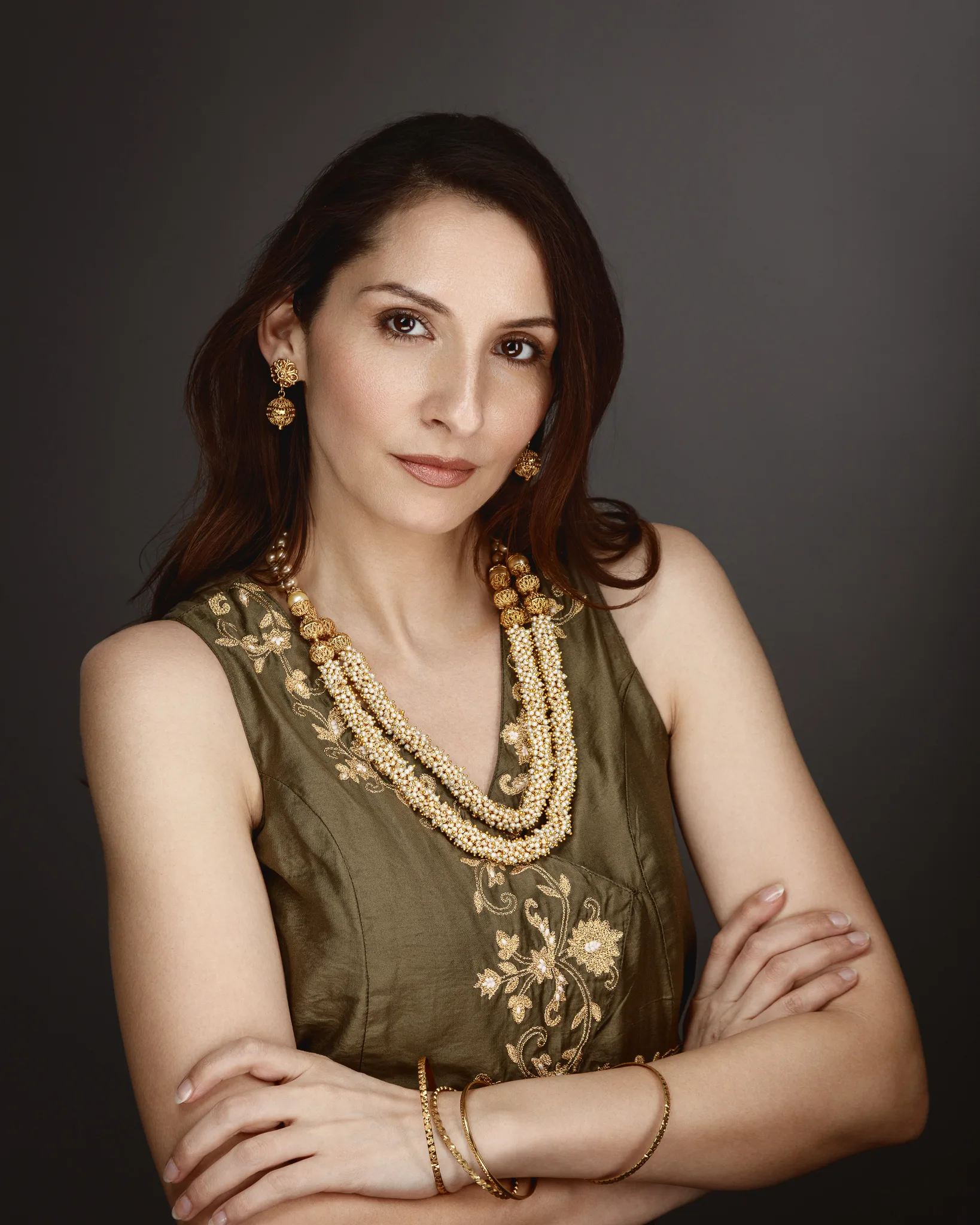 Woman in embroidered dress with gold jewelry