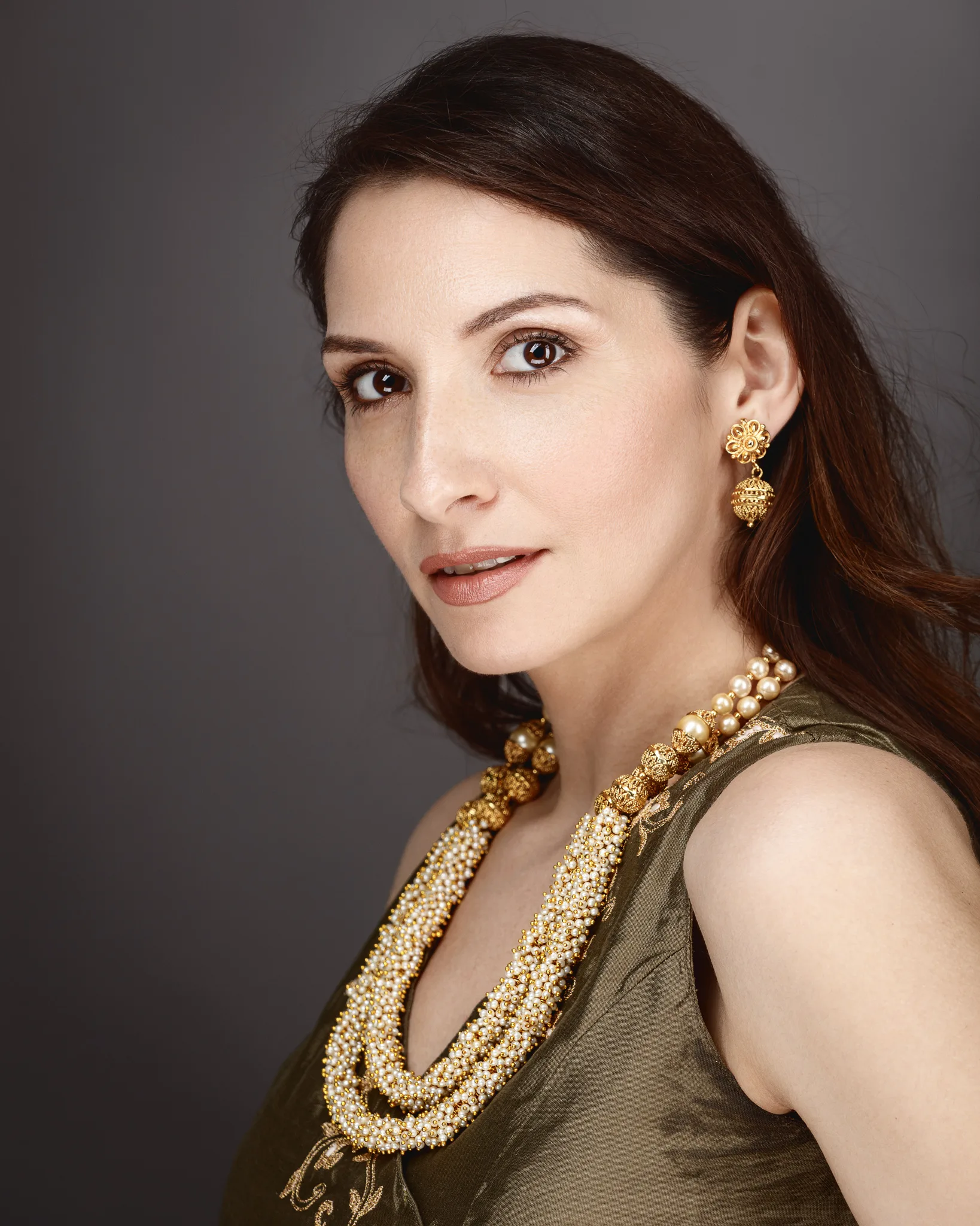 Elegant woman wearing gold jewelry