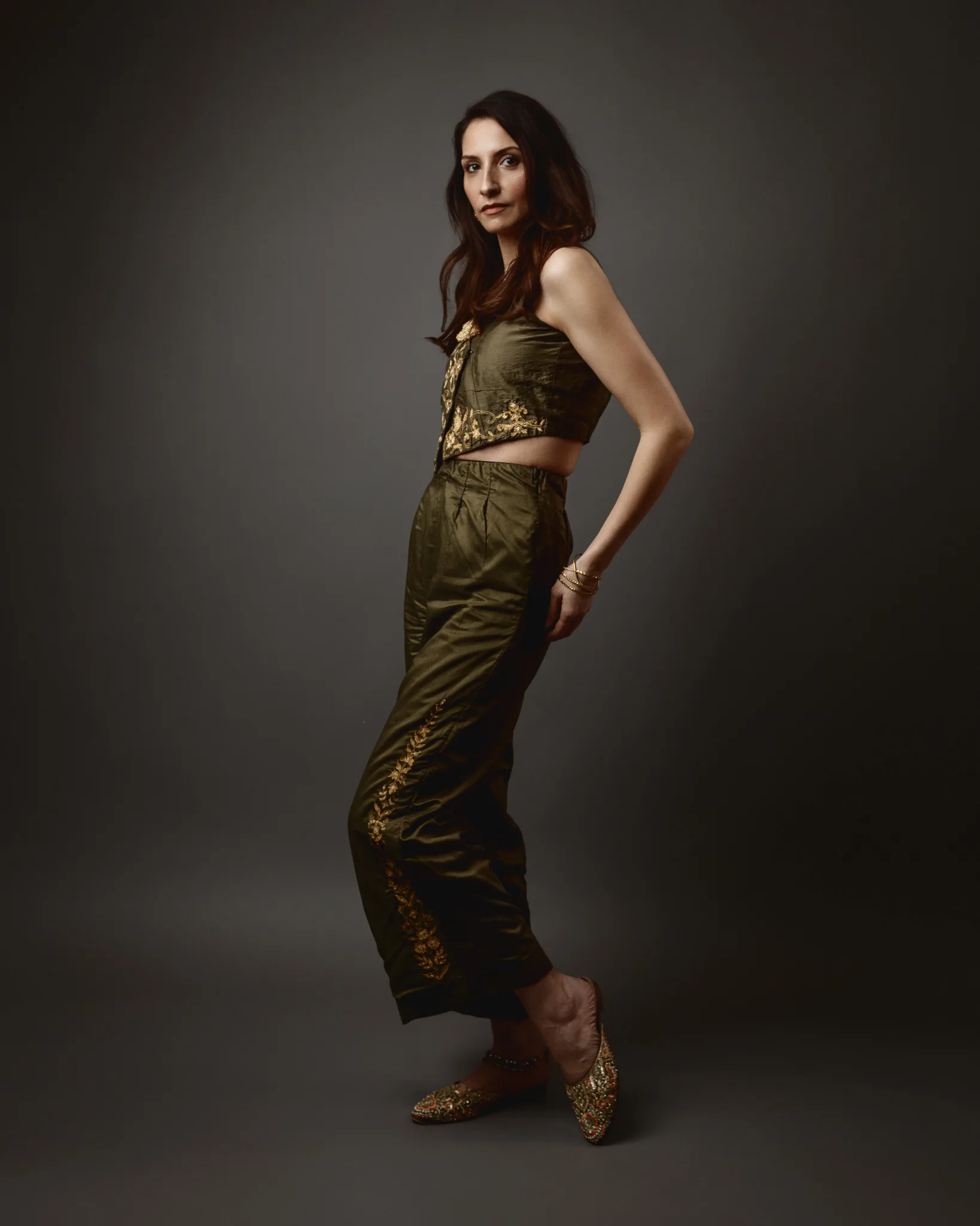 Woman in olive green outfit posing