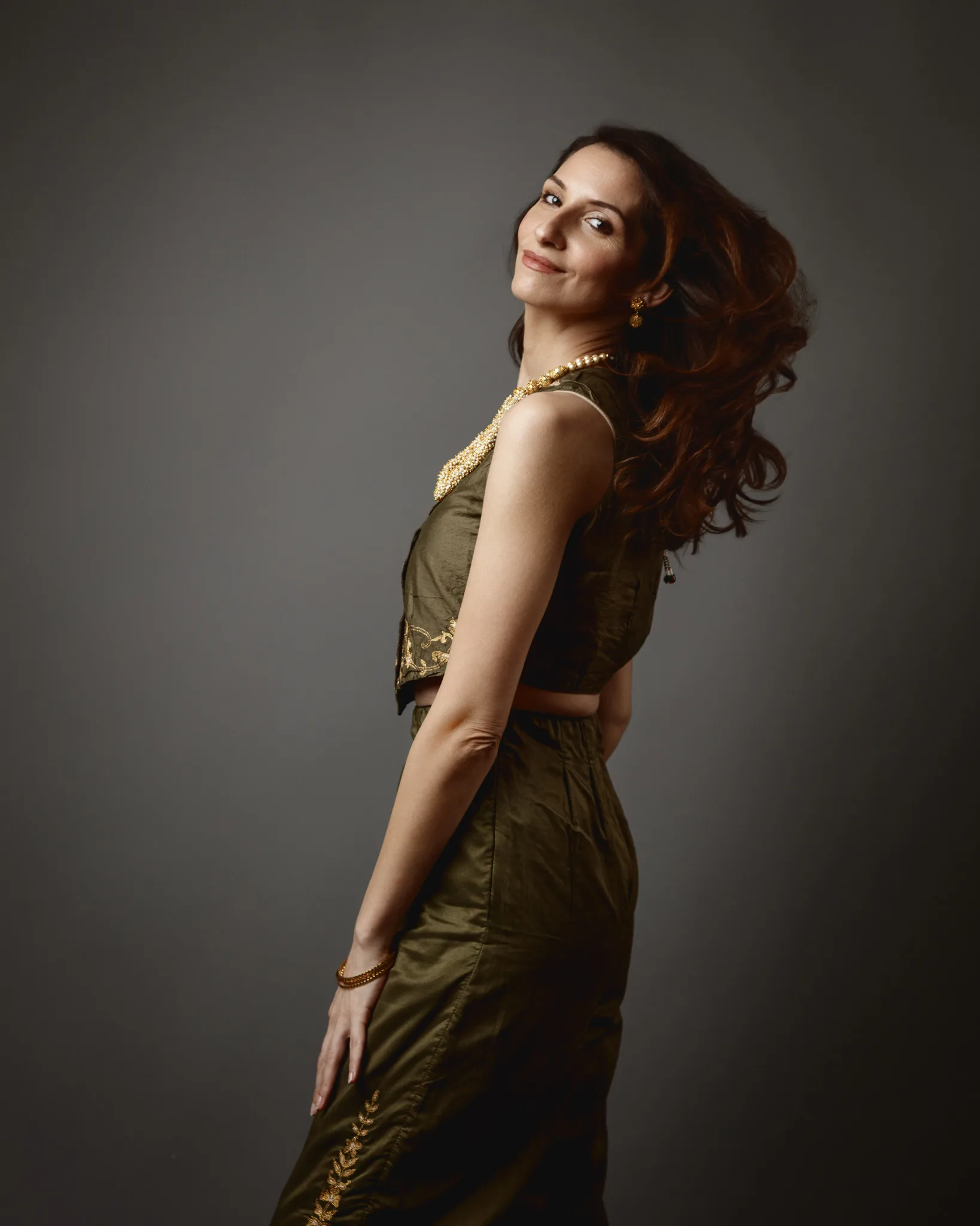 Woman in olive dress with flowing hair