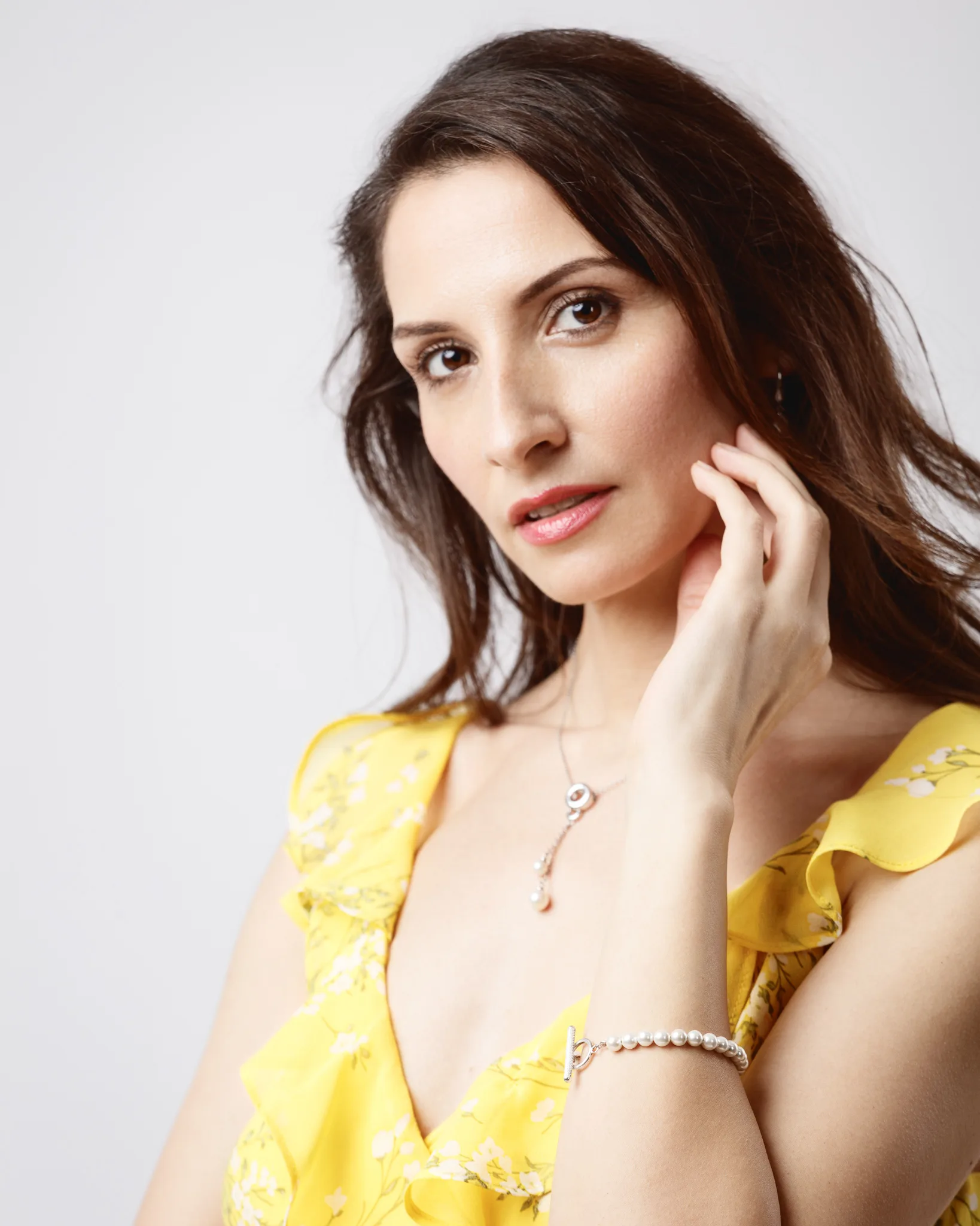 Woman in yellow dress with jewellery