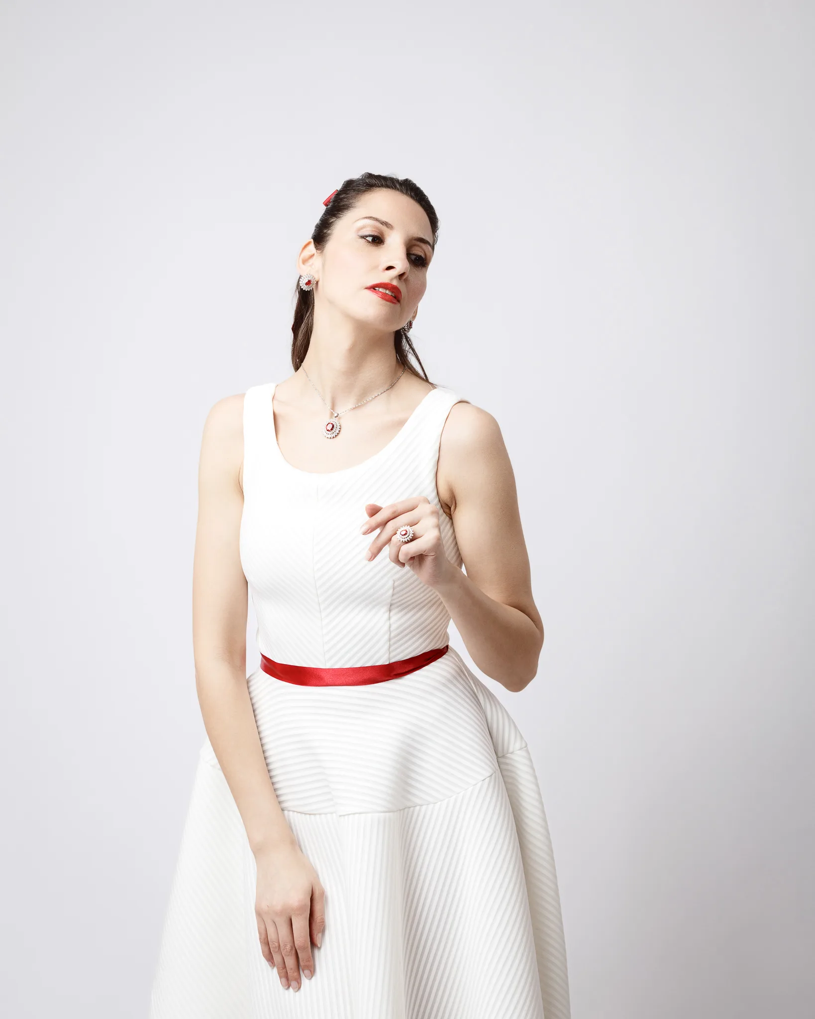 Woman in white dress with red accents