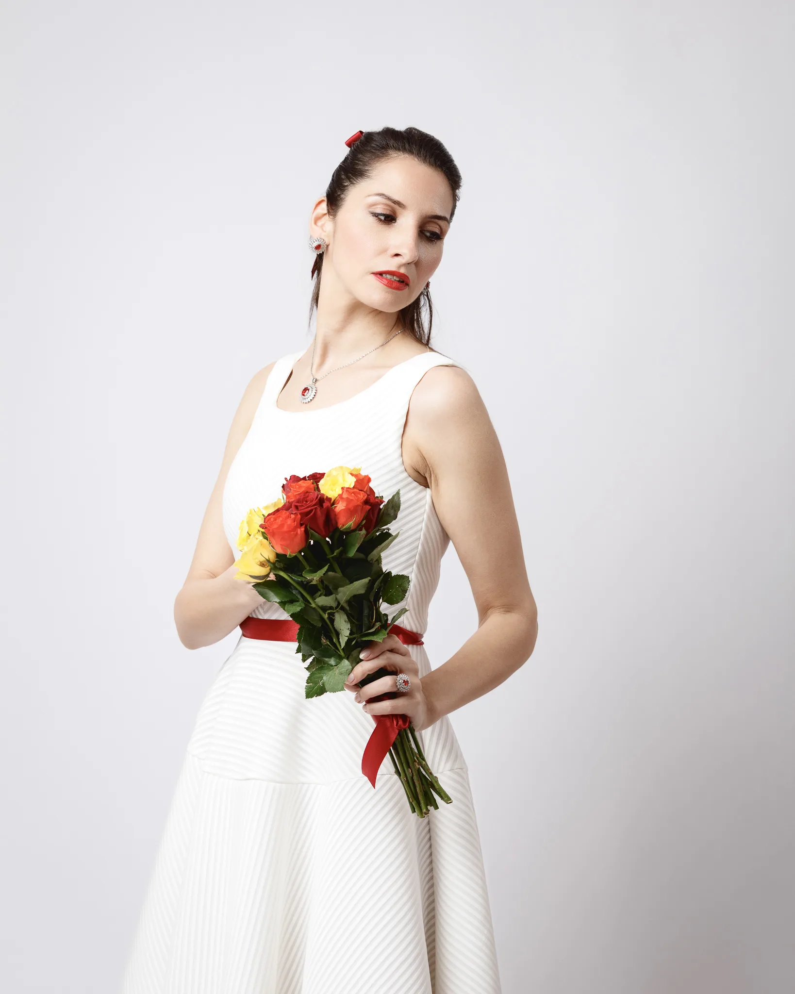 Woman in white dress holding colorful roses