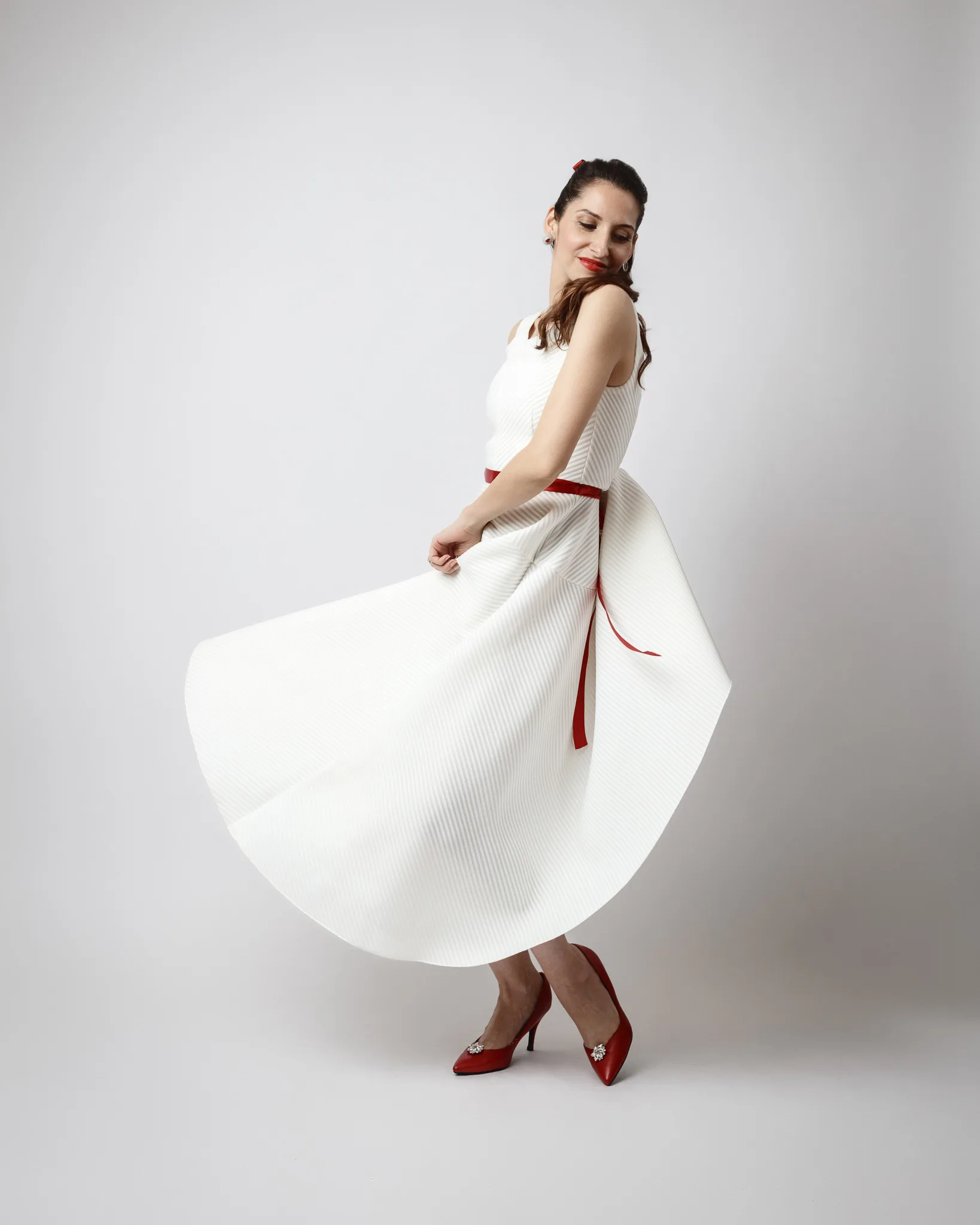 Woman in white dress twirling gracefully