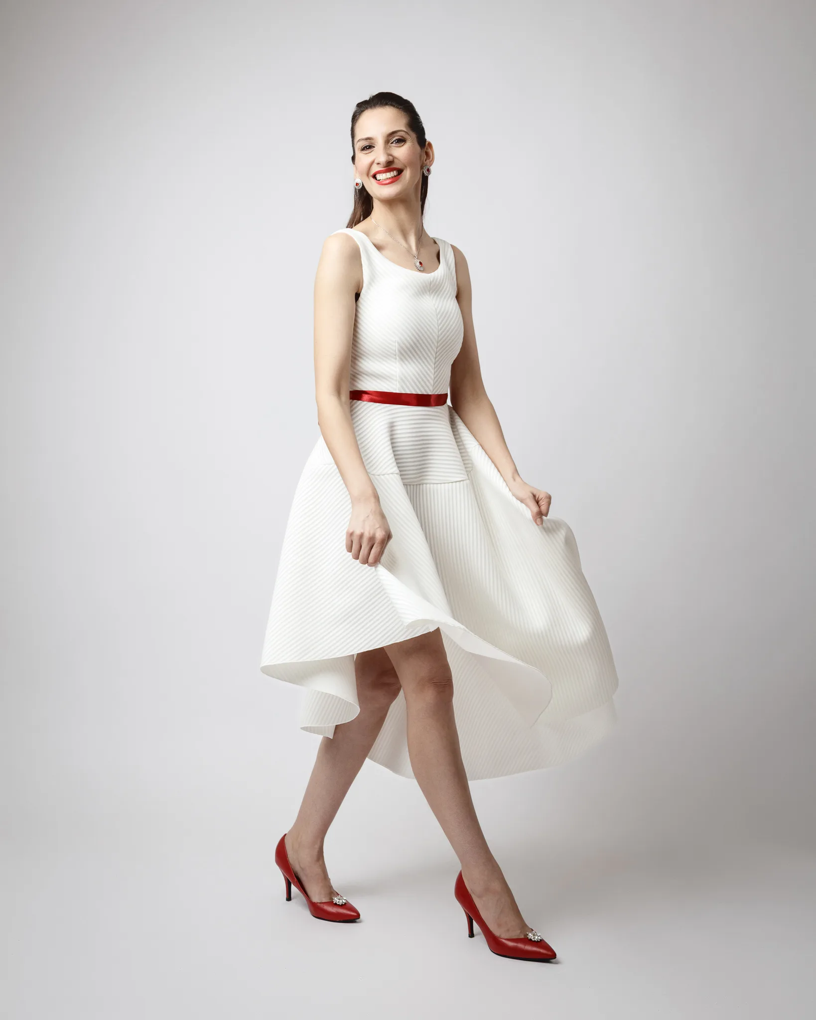 Woman in white dress with red accents