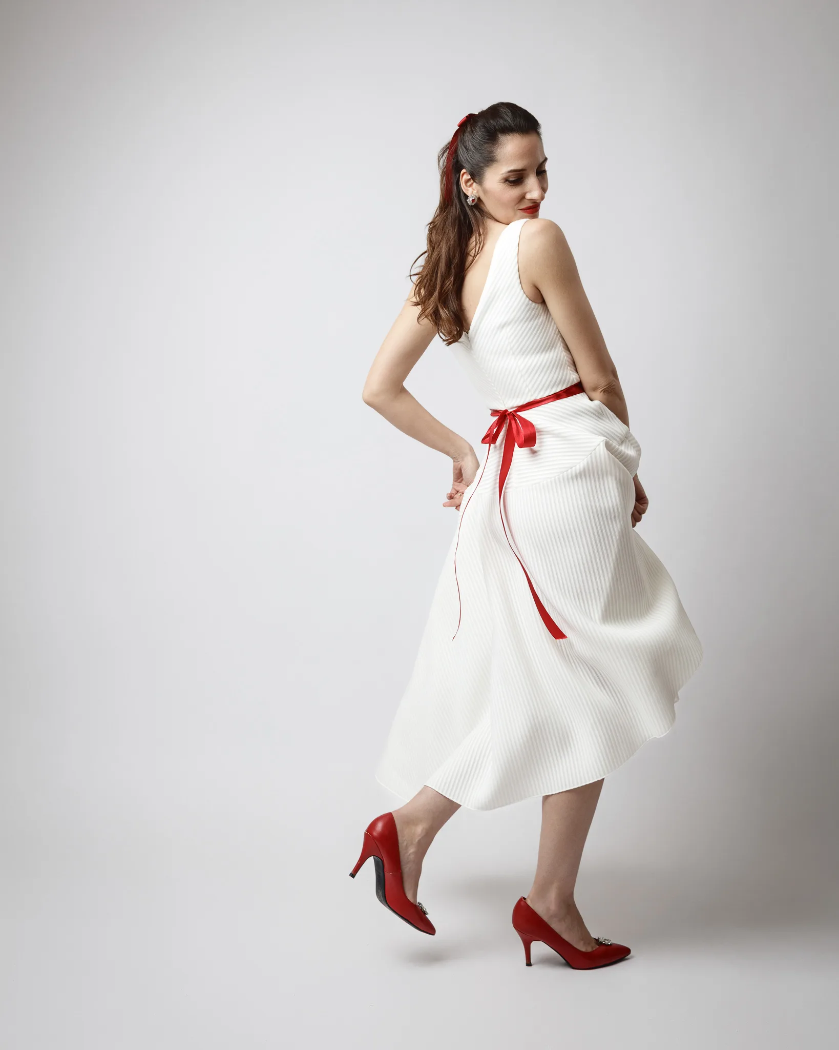 Woman in white dress with red accents