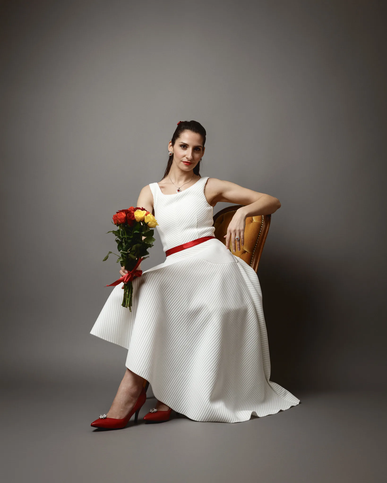 Woman in white dress holding flowers