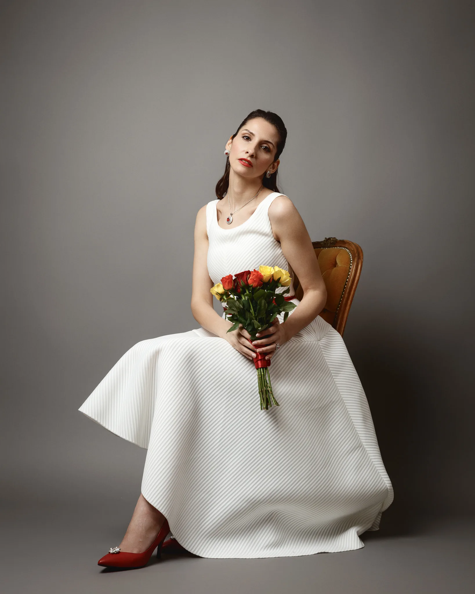 Woman in white dress holding flowers