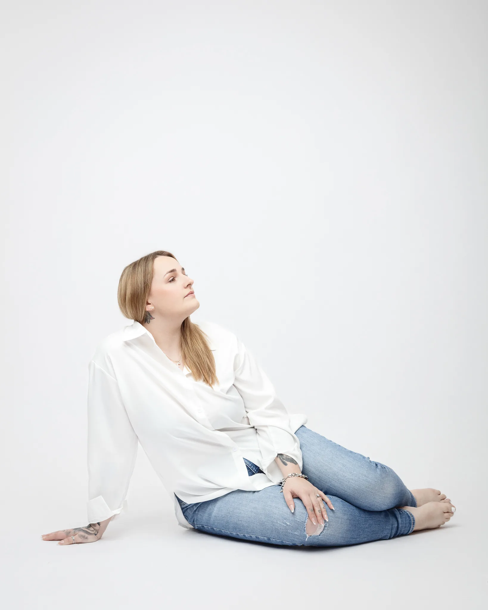 Woman in white shirt sitting casually