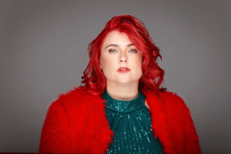 Person with red hair and red coat