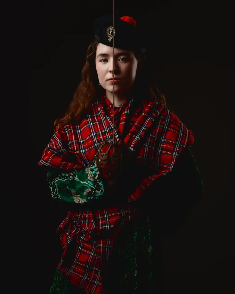 Woman in traditional Scottish attire with sword