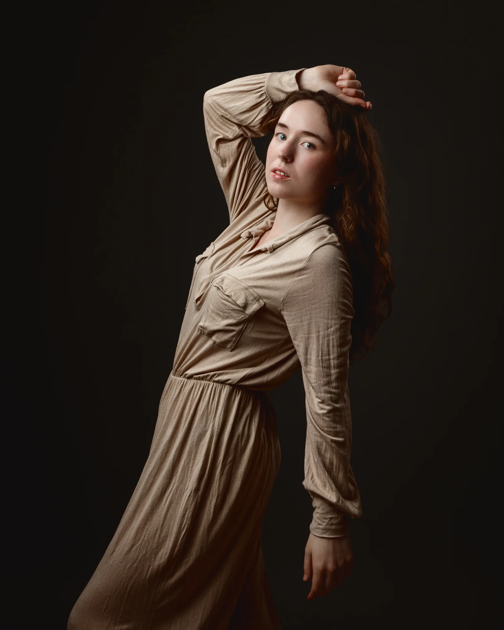 Woman posing in a beige dress