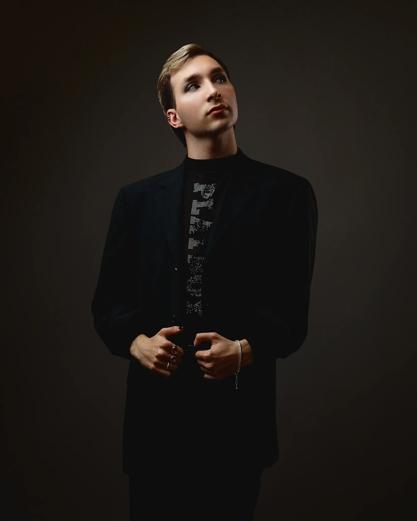 Person in smart black attire looking upwards