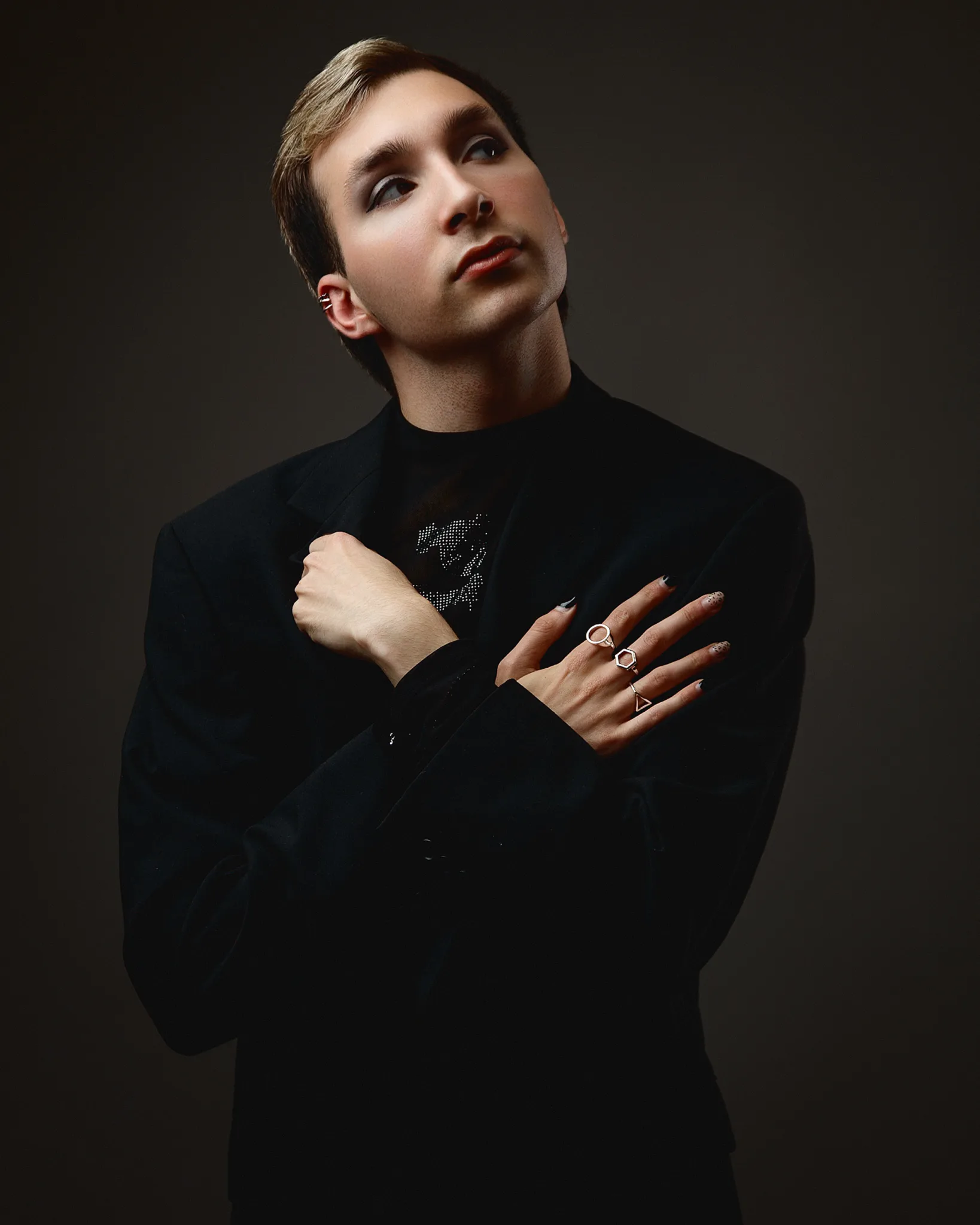 Person in black suit with nail art