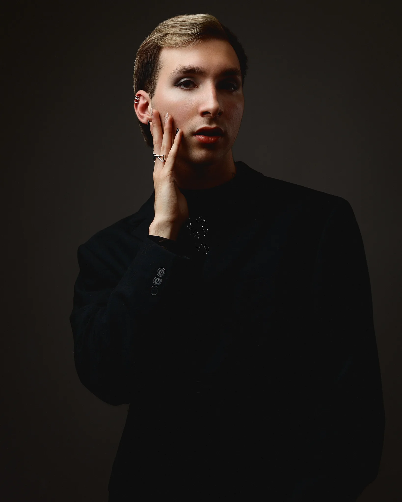 Elegant person in dark clothing posing