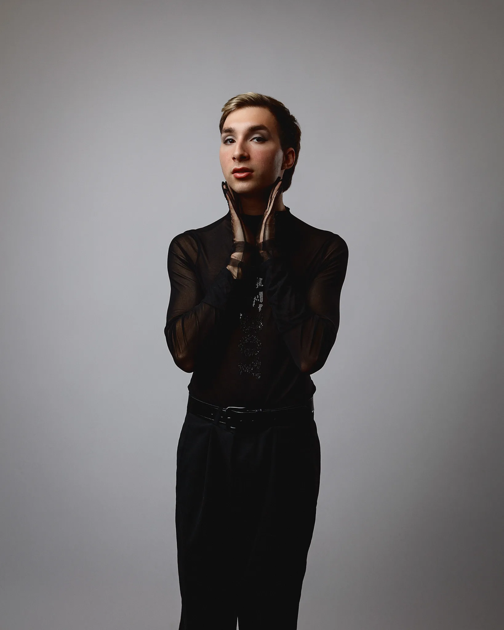 Person posing in sheer black outfit