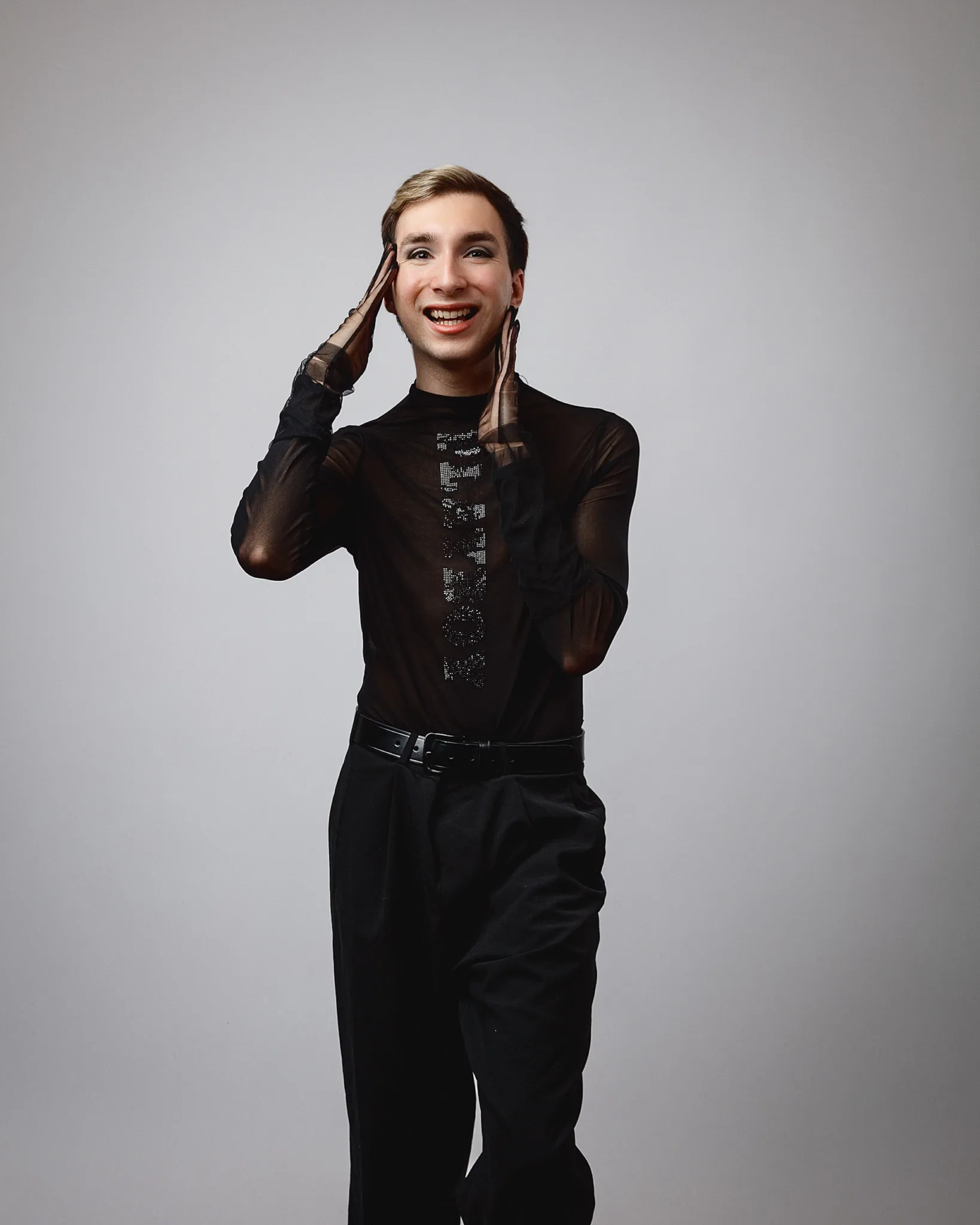 Smiling person in black sheer top