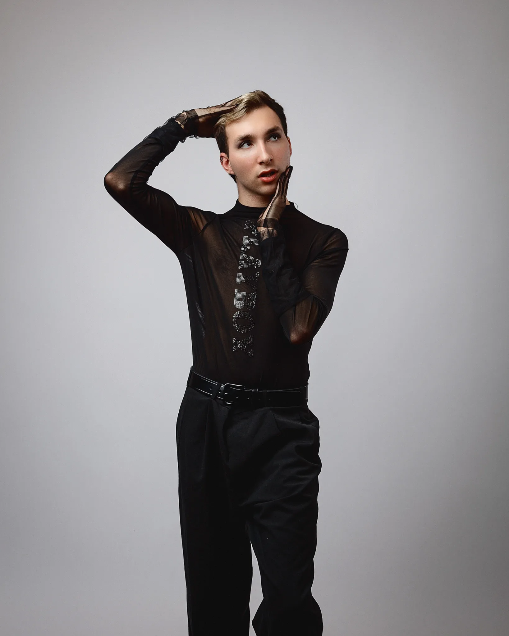 Person posing in sheer black outfit