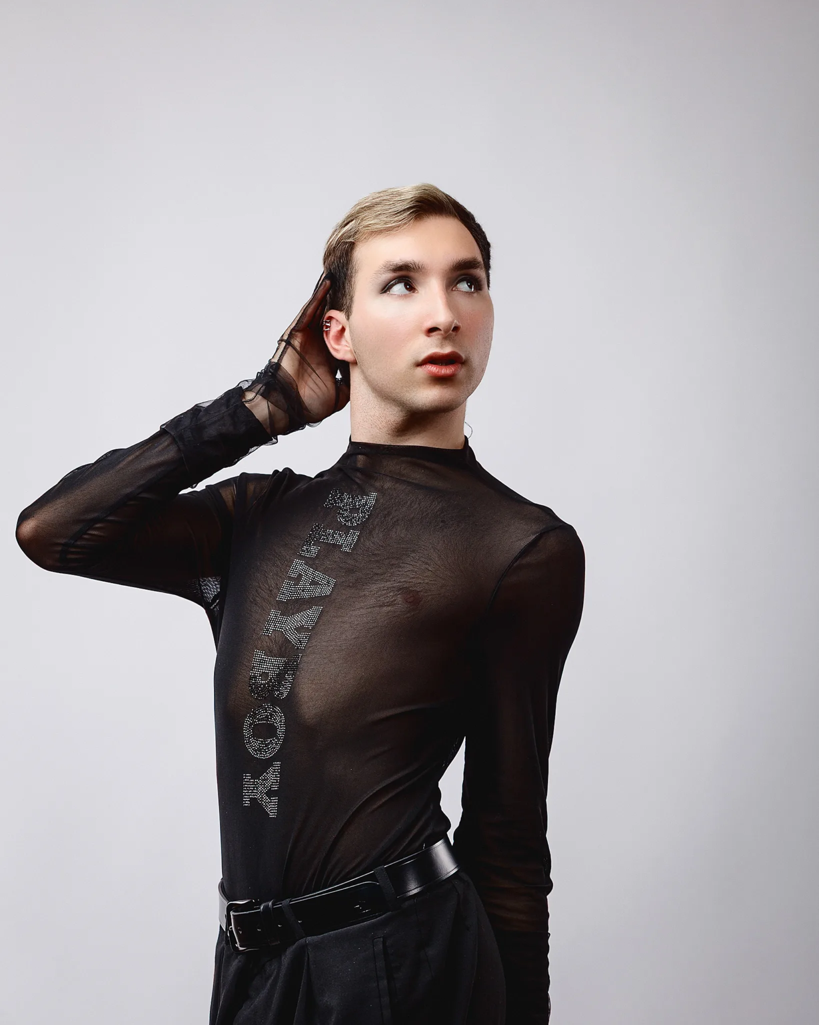 Person posing in sheer black top