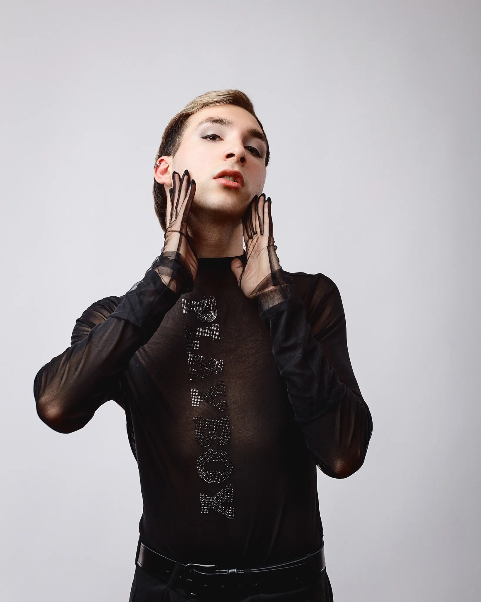 Person in sheer black outfit posing