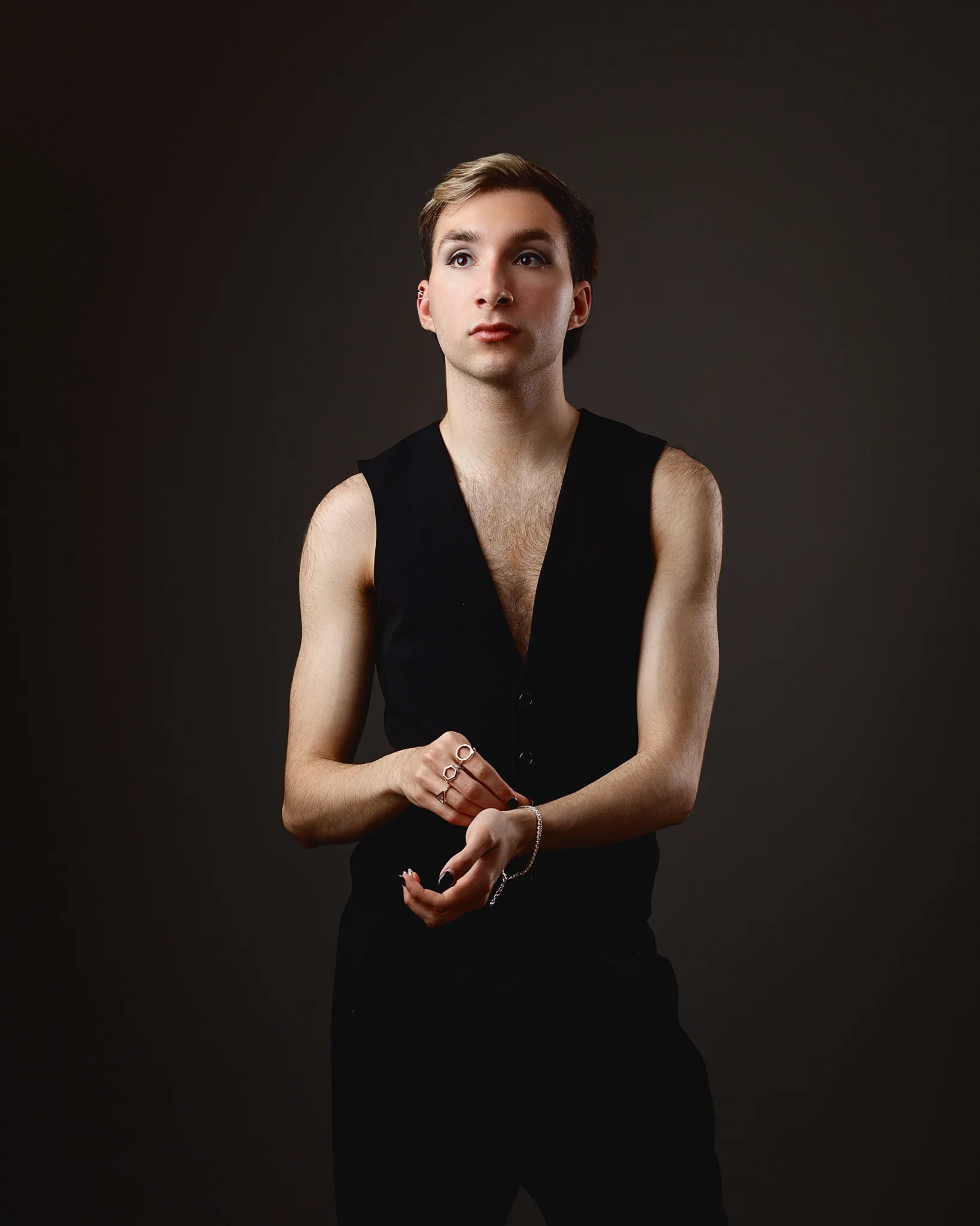 Person in black outfit with rings