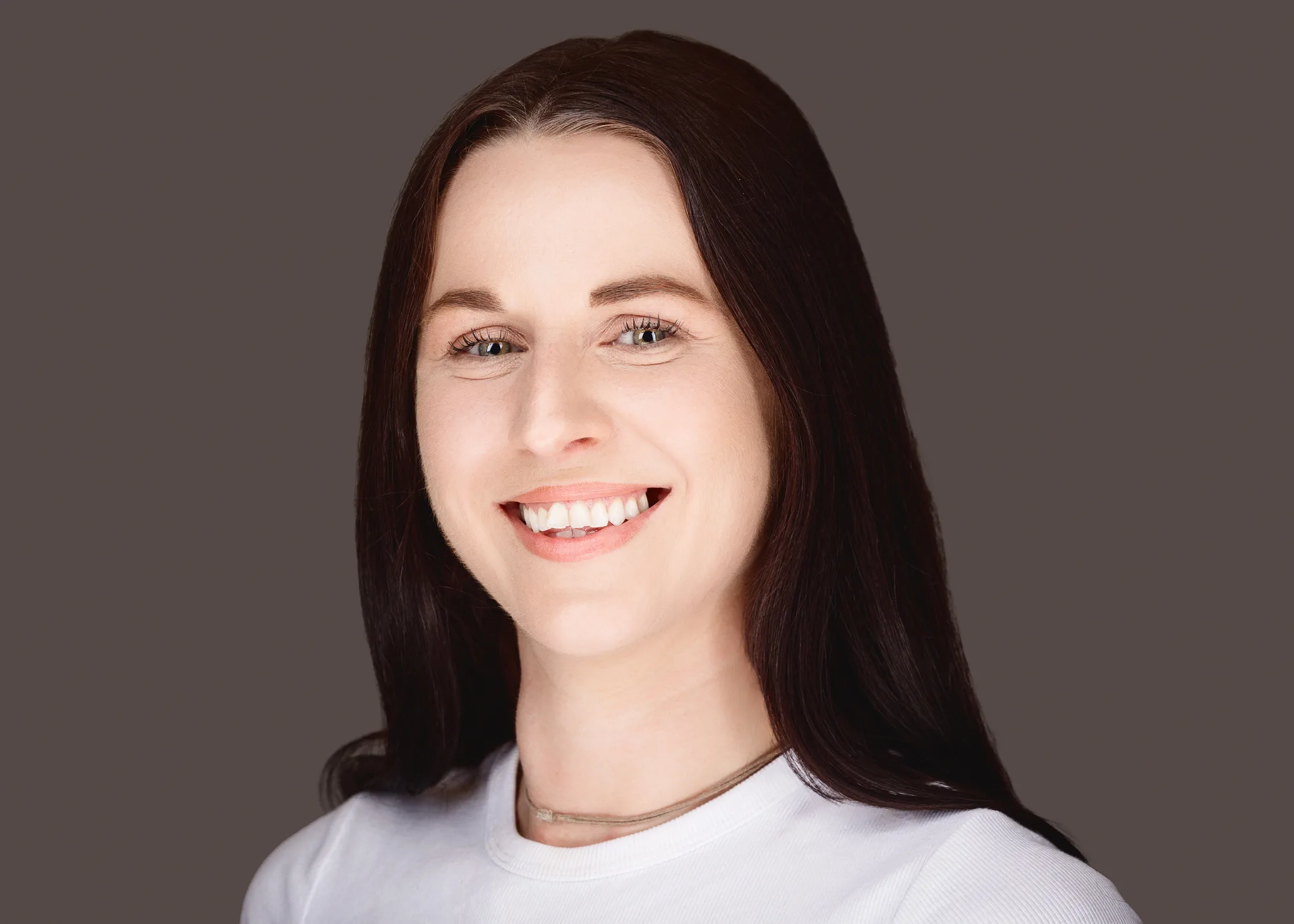 Smiling woman with long dark hair headshot