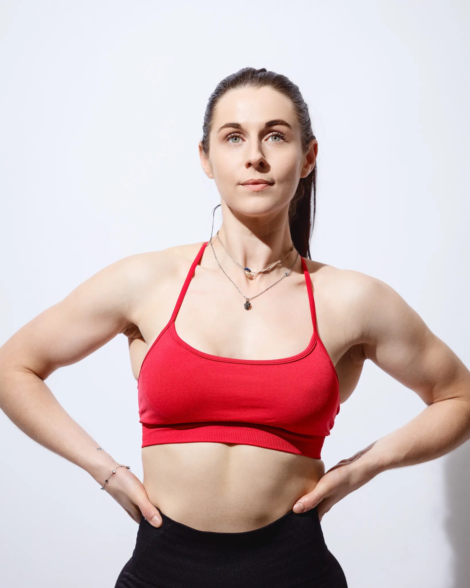 Woman in red sports bra posing confidently