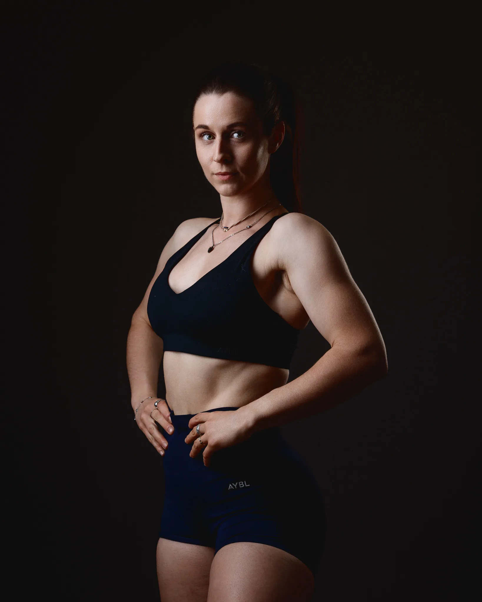 Muscular woman posing in black sportswear