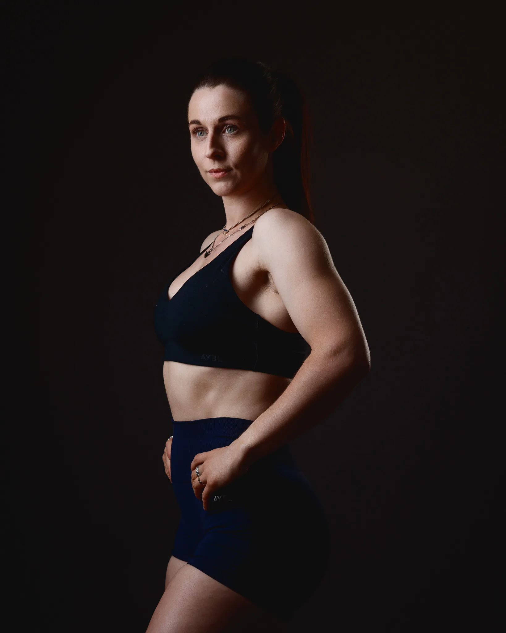 Athletic woman posing in black sportswear